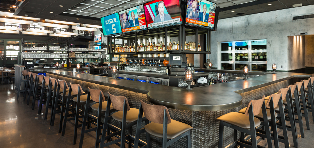 Bar and bar stools inside the Bartolotta Collection restaurant ABV Social in Wisconsin, a Tri-North Builders project.
