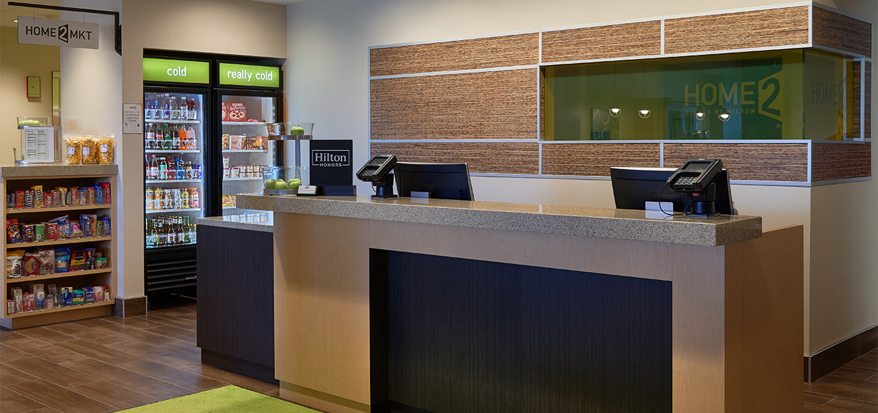 Front desk in the lobby of the Tri-North Builders project at Home2Suites by Hilton Madison Central Alliant Energy Center.