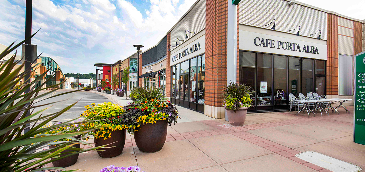 Cafe, outdoor seating, stores and parking at the Tri-North Builders Hilldale mall project in Madison.