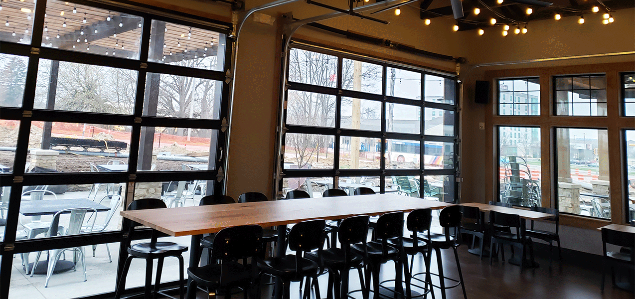 Long table, chairs and window inside Liberty Station restaurant built by Tri-North Builders