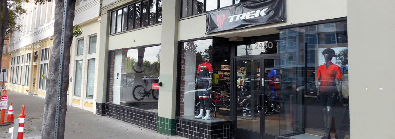 Mannequins and bikes are seen in the entrance windows of a Trek bike store built by Tri-North.
