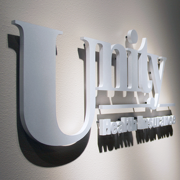 Unity Health Insurance office sign logo inside the UW Health Office building in Wisconsin.