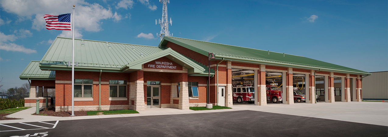 Front of building at Tri-North Builders' Waukesha Fire Department remodel project with fire trucks and garage doors.